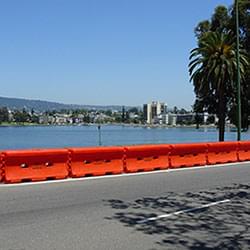A series of TrafFix Water-Cable Barriers linked together along a roadway